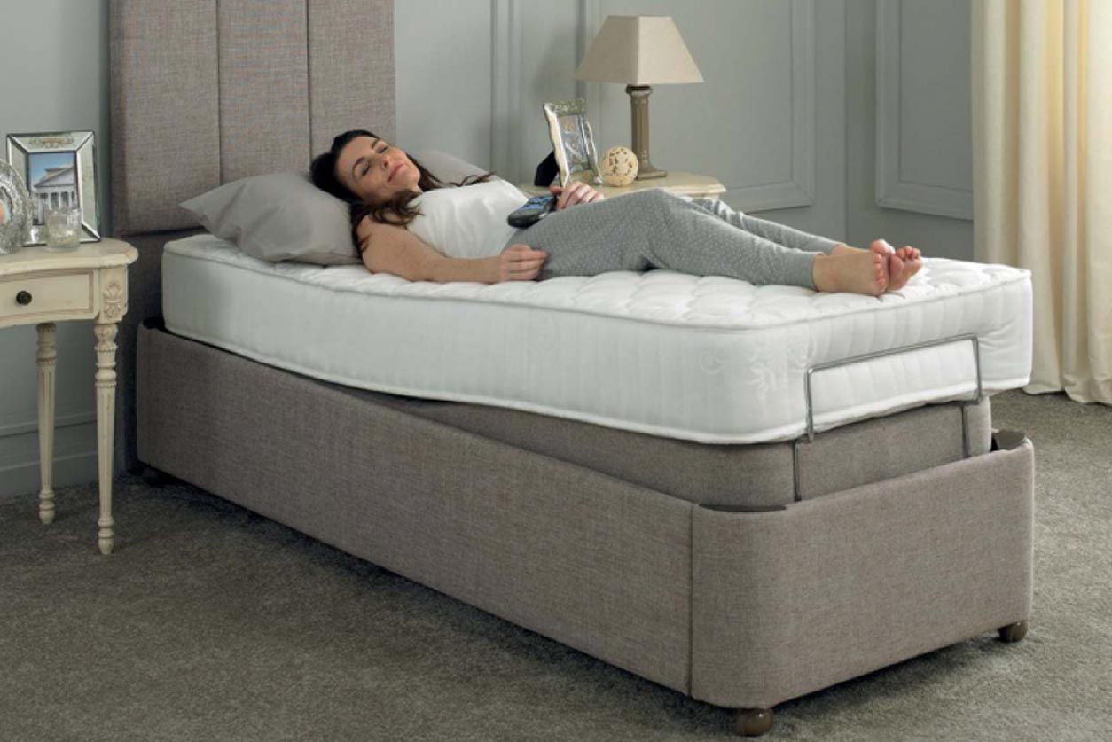 Woman lying on an adjustable bed base.